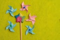 A colorful star shape lollipop with colorful pinwheels on a yellow background Royalty Free Stock Photo