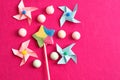 A colorful star shape lollipop with colorful pinwheels and marshmallows on a pink background Royalty Free Stock Photo