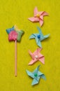 A colorful star shape lollipop with colorful pinwheels on a yellow background Royalty Free Stock Photo