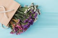 Colorful statice limonium flowers on blue wood.