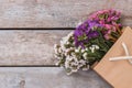 Colorful statice limonium flowers in paper bag.