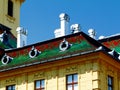 colorful steep ceramic tile mansard roof. red and green enamel finish. decorative white stucco chimneys. Royalty Free Stock Photo