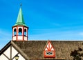 colorful steeple and dormer window on thatched roof