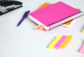 Colorful sticky bookmarks for Notebook, staplers and pen on white background. Selective focus. Royalty Free Stock Photo