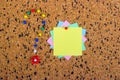 colorful sticky notes on cork bulletin board. Question mark made of pushpins