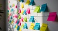 Colorful sticky notes create a flowchart on a white wall for project management ideas Royalty Free Stock Photo
