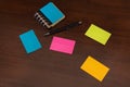 Colorful sticky notes and pen on brown wooden desk Royalty Free Stock Photo