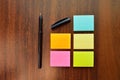 Colorful sticky notes and a pen on a table Royalty Free Stock Photo