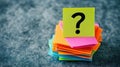 Question Mark Atop a Stack of Colorful Sticky Notes on Gray Surface Royalty Free Stock Photo