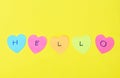 Colorful sticky paper note with hearth shape write hello on yellow foam board  background Royalty Free Stock Photo