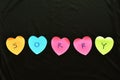 Colorful sticky paper note with hearth shape write sorry on black fabric background Royalty Free Stock Photo