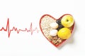 Colorful still life of a bowl of fresh fruit with a red heart beside it