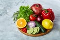 Still life of fresh organic vegetables on wooden plate over wooden background, selective focus, close-up