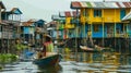 Colorful stilt houses and local in rowboat on serene water Royalty Free Stock Photo