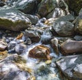 Colorful stones in the clear cold water of a creek Royalty Free Stock Photo