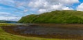 Colorful stranded fishing boats at low tide in Loch Harport on the picturesque west coast of the Isle of Skye