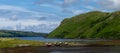 Colorful stranded fishing boats at low tide in Loch Harport on the picturesque west coast of the Isle of Skye