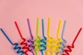 Colorful straws on pink background, top view Royalty Free Stock Photo