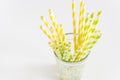 Colorful Straws Yellow and Green Straws in Glass White Background Copy Space Royalty Free Stock Photo