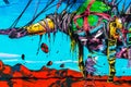 Colorful street art graffiti mural showing ninja robot flying over a man in an apocalytical scenario