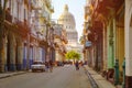 Colorful street in Old Havana at sunset with the Capitol building Royalty Free Stock Photo