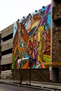 Colorful street painting of a male and a horse on the parking garage in Ogden City Utah