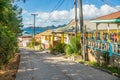 Colorful street with residential houses at the bay, of Mayreau island with Union island in the background, Saint Vincent and the