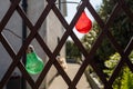 Colorful string bulbs hanging on a wooden fence in a back yard. Getting ready to party concept. Selective focus. Warm sunny day