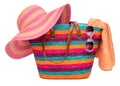 Colorful striped beach bag with a straw hat towel and sunglasses Royalty Free Stock Photo