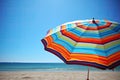 Colorful striped beach umbrellas on the background of the beach and blue sky. Generative AI Royalty Free Stock Photo