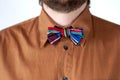 Colorful striped bow tie with brown shirt.