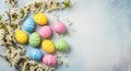 Colorful Striped Easter Eggs and Cherry Blossoms on a Textured Light Blue Background painted Royalty Free Stock Photo