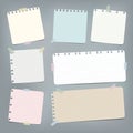 Colorful striped, ruled note, copybook, notebook paper stuck with sticky tape on grey background. Royalty Free Stock Photo