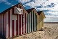 Colorful stripy beach huts.