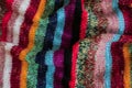 Colorful stripy woolen fabric texture close up. knitted background. Close up texture . wrinkled and shadows, top view