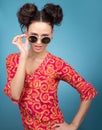 Colorful Studio portrait of young woman in sunglasses. Bright red blouse Royalty Free Stock Photo