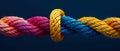 Colorful sturdy rope with knot on blue background. Concept of teamwork, unity, cooperation, partnership, and support. Royalty Free Stock Photo