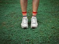 Colorful stylish socks on green field