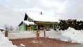 Colorful suburban house with large courtyard covered in snow