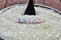 Colorful sugar text from tiled letter blocks and sugar pile on a spoon suggesting dieting concept,sugar writing text Royalty Free Stock Photo
