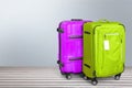 Two Colorful suitcases on wooden background Royalty Free Stock Photo