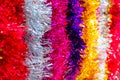 Colorful Sukkot or Sukkos or Christmas tinsel. New year`s fluffy gold, purple, silver, yellow, pink tinsel. Royalty Free Stock Photo
