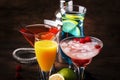 Colorful summer cocktails. Cold alcoholic beverages and drinks: mimosa, cosmopolitan, raspberry margarita and blue hawaii on Royalty Free Stock Photo