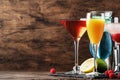 Colorful summer cocktails. Cold alcoholic beverages and drinks: mimosa, cosmopolitan, raspberry margarita and blue hawaii on Royalty Free Stock Photo