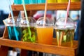 Colorful summer cold drinks in plastic cups on the display Royalty Free Stock Photo