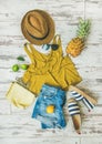 Colorful summer fashion outfit flat-lay over pastel background