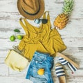 Colorful summer fashion outfit flat-lay over pastel background, square crop