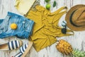 Colorful summer fashion outfit flat-lay over pastel background, top view