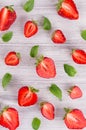 Colorful summer fruit background with slice strawberry and mint leaf, top view. Royalty Free Stock Photo