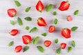 Colorful summer fruit background with slice strawberry and mint leaf, top view. Royalty Free Stock Photo